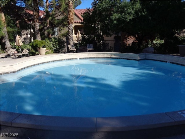 view of swimming pool featuring fence and a fenced in pool