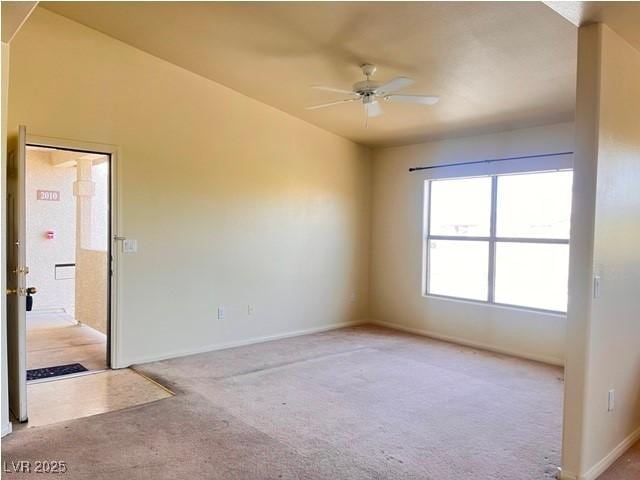 unfurnished room featuring baseboards, ceiling fan, and light carpet