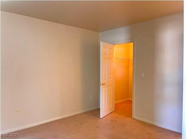 unfurnished bedroom with baseboards and light carpet