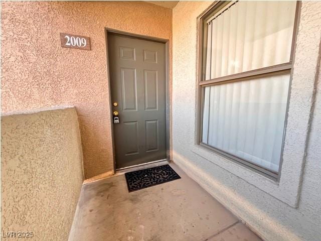 doorway to property with stucco siding