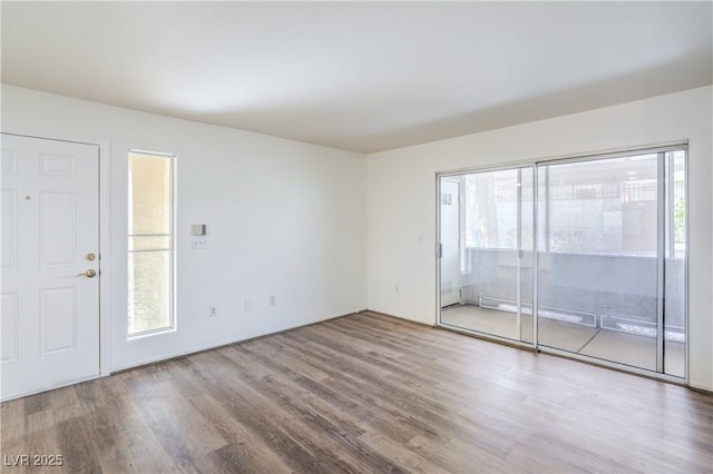 5710 E Tropicana Ave Unit 1017, Las Vegas, NV 89122 - unfurnished room with a healthy amount of sunlight and wood finished floors