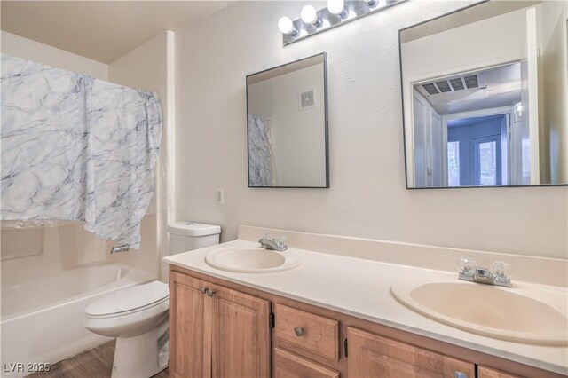 5710 E Tropicana Ave Unit 1017, Las Vegas, NV 89122 - bathroom featuring double vanity, toilet, visible vents, and a sink