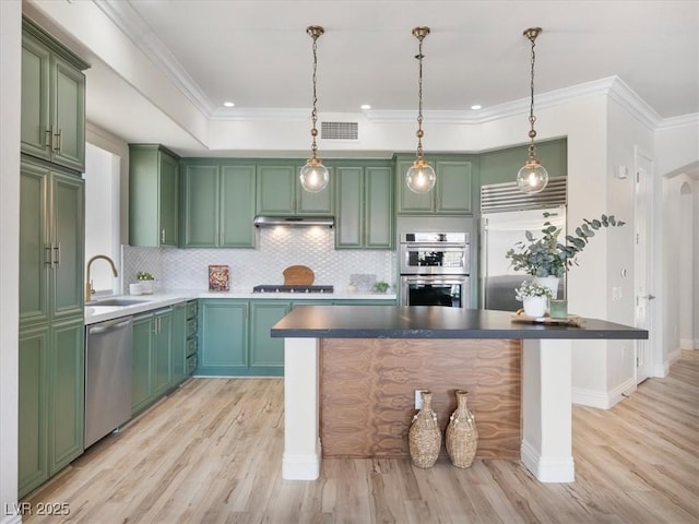 kitchen featuring a sink, appliances with stainless steel finishes, green cabinetry, and visible vents