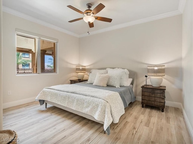 bedroom featuring baseboards, ornamental molding, light wood-style flooring, and a ceiling fan