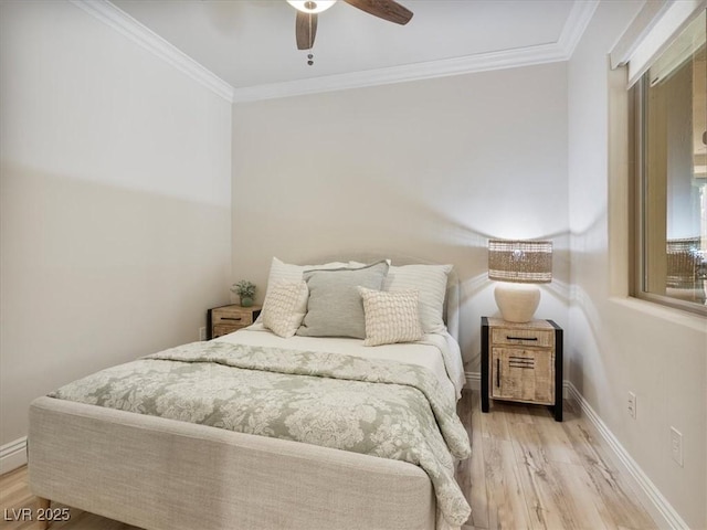 bedroom with ceiling fan, ornamental molding, baseboards, and wood finished floors