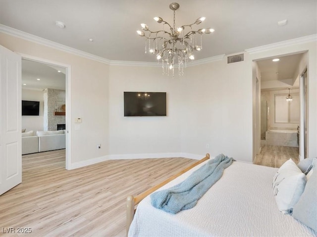 bedroom featuring baseboards, light wood-style floors, crown molding, and visible vents