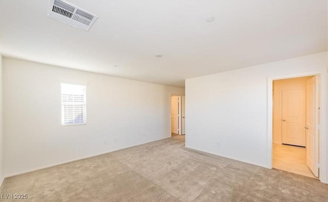 carpeted empty room with visible vents