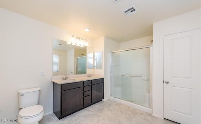 bathroom with a sink, toilet, a stall shower, and visible vents