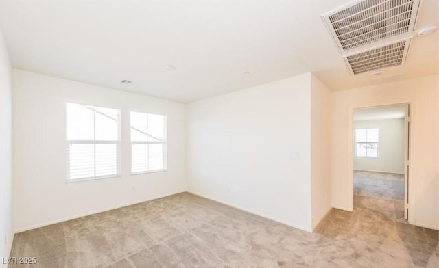 unfurnished room with carpet flooring and visible vents