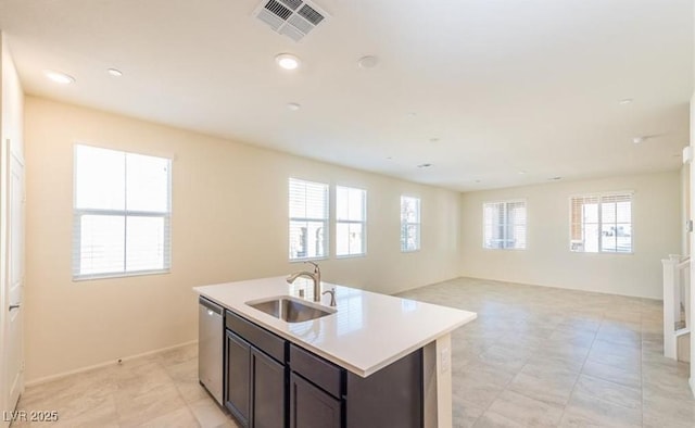 kitchen with a sink, a healthy amount of sunlight, visible vents, and dishwasher