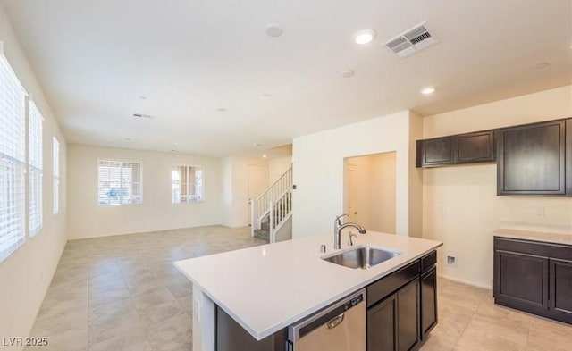 kitchen with dishwasher, dark brown cabinets, visible vents, a sink, and light countertops