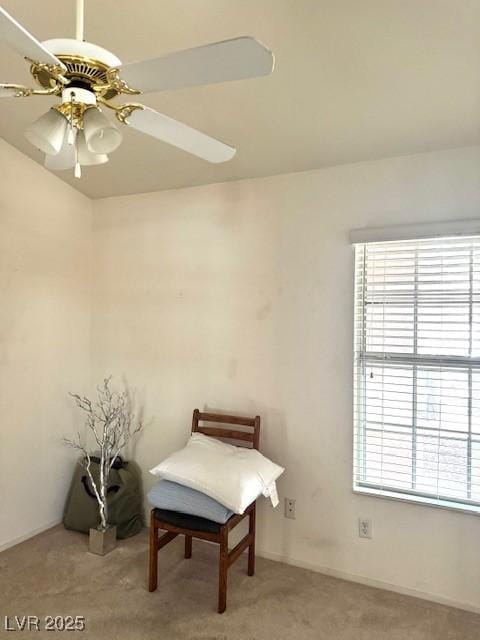 living area with baseboards, carpet flooring, and ceiling fan