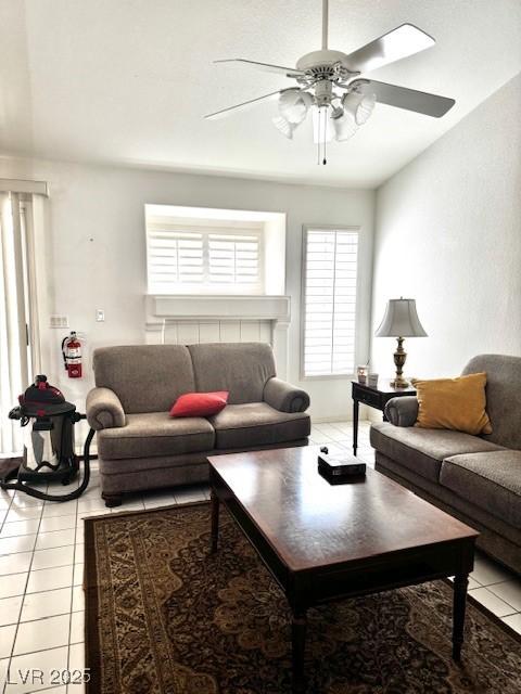 living area featuring light tile patterned floors and a ceiling fan