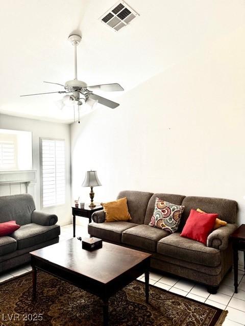 living area with light tile patterned floors, a ceiling fan, and visible vents