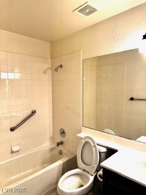 full bath with toilet, washtub / shower combination, vanity, and visible vents
