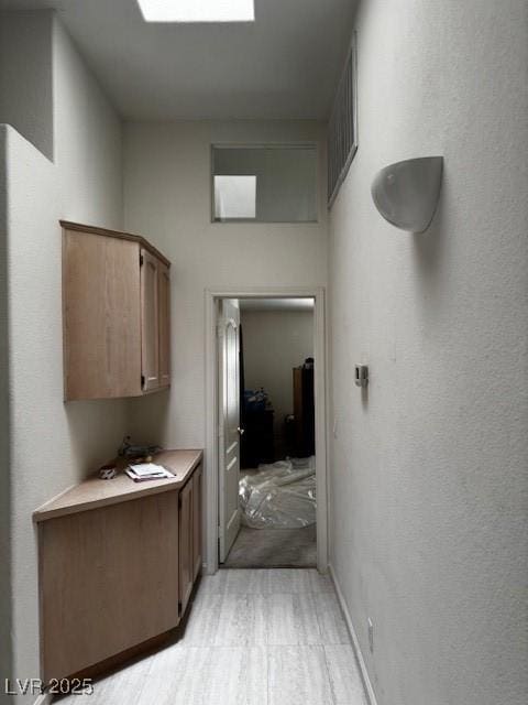 hall featuring a textured wall