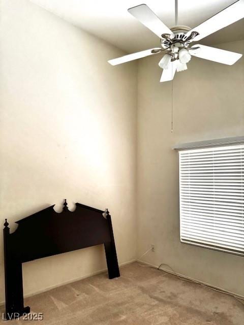 interior space featuring light colored carpet and a ceiling fan