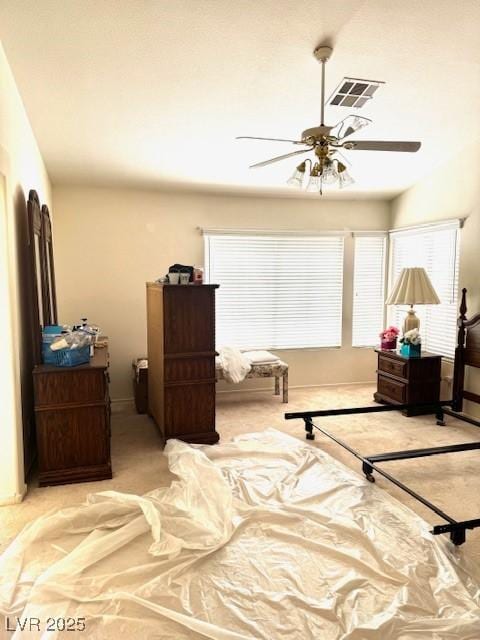 carpeted bedroom with ceiling fan, baseboards, and visible vents