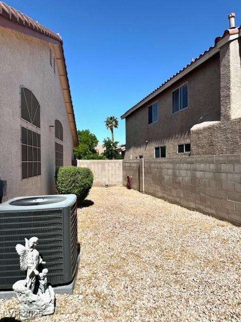 view of yard with a fenced backyard and cooling unit