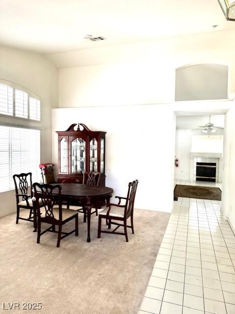 1812 Jack Rabbit Way, Las Vegas, NV 89128 - dining room with high vaulted ceiling, light tile patterned flooring, light carpet, and a ceiling fan