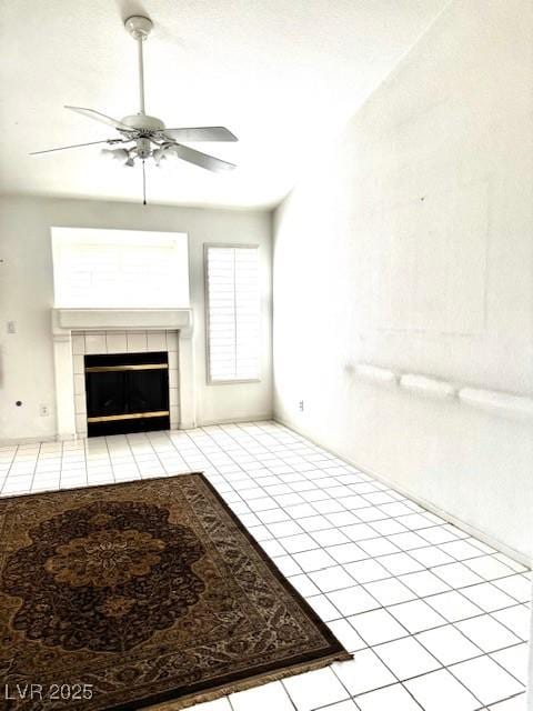 1812 Jack Rabbit Way, Las Vegas, NV 89128 - unfurnished living room featuring a ceiling fan, a tiled fireplace, and tile patterned flooring