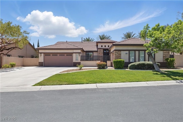 prairie-style home featuring driveway, fence, a garage, stucco siding, and stone siding