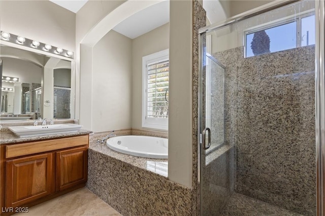 full bath with a bath, vanity, tile patterned flooring, and a stall shower