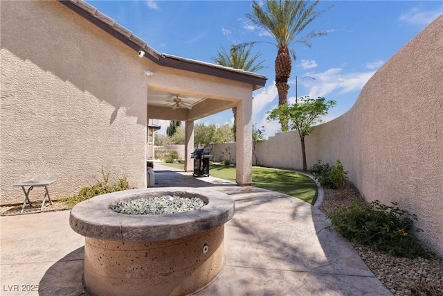 view of patio featuring a fenced backyard, area for grilling, and a ceiling fan