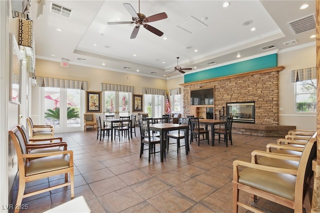 dining area featuring a tray ceiling, a ceiling fan, and visible vents