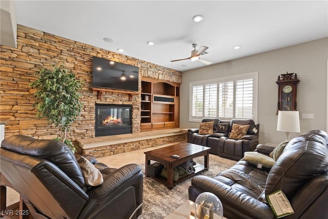 living area with built in features, a fireplace, ceiling fan, and recessed lighting