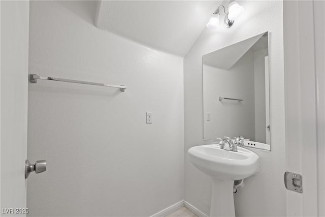 4076 Rocky Beach Dr, Las Vegas, NV 89115 - bathroom featuring baseboards and lofted ceiling