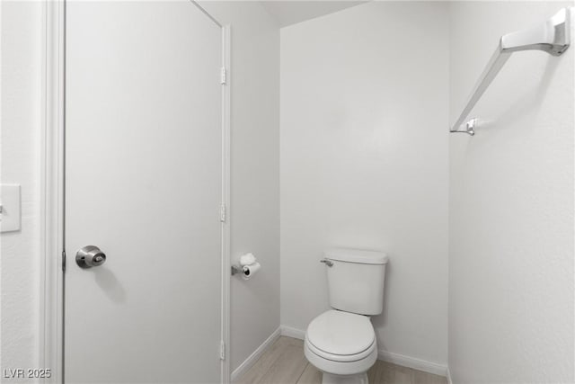 4076 Rocky Beach Dr, Las Vegas, NV 89115 - bathroom with toilet, wood finished floors, and baseboards