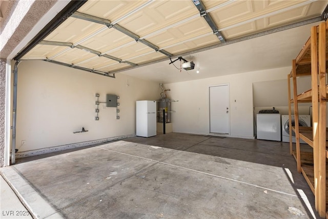 4076 Rocky Beach Dr, Las Vegas, NV 89115 - garage featuring freestanding refrigerator, a garage door opener, secured water heater, and washer and clothes dryer