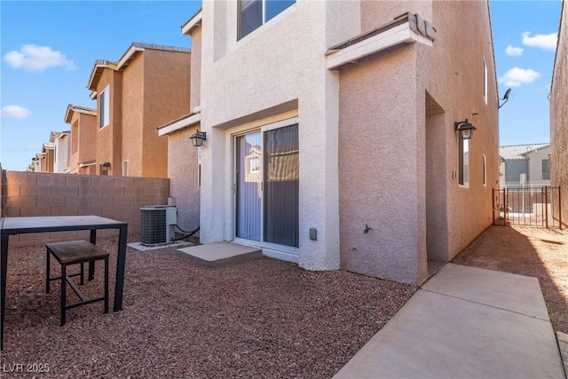 4076 Rocky Beach Dr, Las Vegas, NV 89115 - back of property featuring cooling unit, stucco siding, and fence