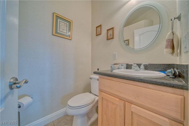 bathroom featuring tile patterned floors, toilet, and vanity