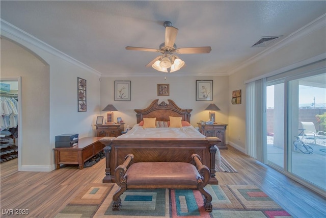 bedroom with baseboards, light wood finished floors, visible vents, and access to exterior