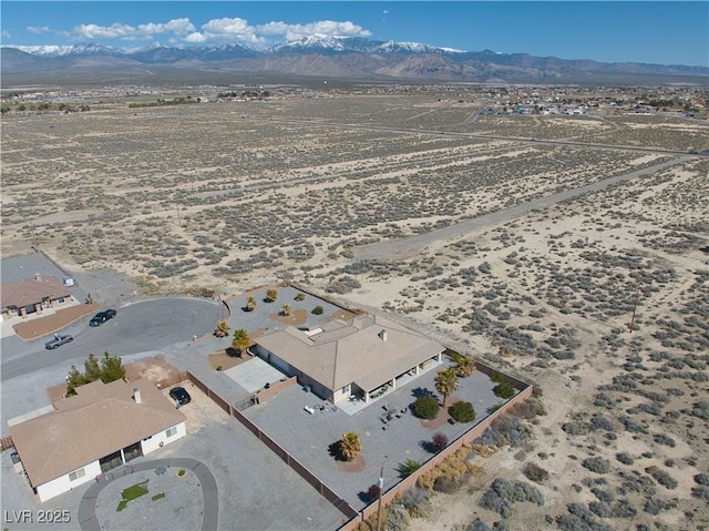 birds eye view of property with a mountain view and view of desert