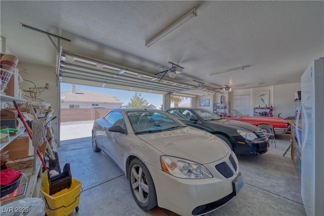 garage with freestanding refrigerator and a garage door opener