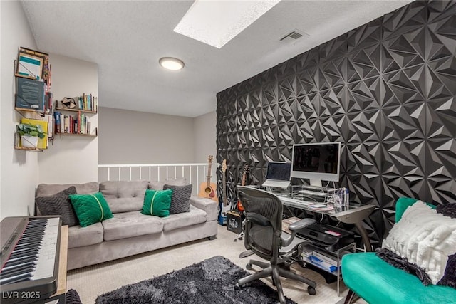 carpeted office featuring a textured ceiling, visible vents, and a skylight