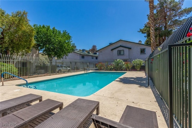 view of swimming pool featuring a fenced backyard, a patio, and a fenced in pool