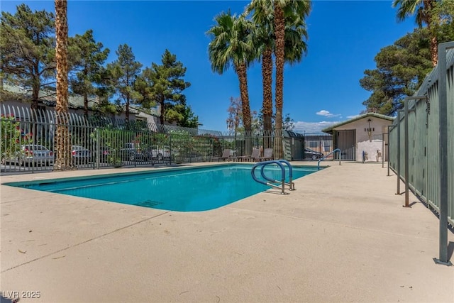 pool featuring a patio and fence