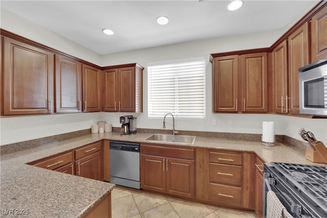 kitchen with recessed lighting, brown cabinetry, light tile patterned flooring, a sink, and stainless steel appliances