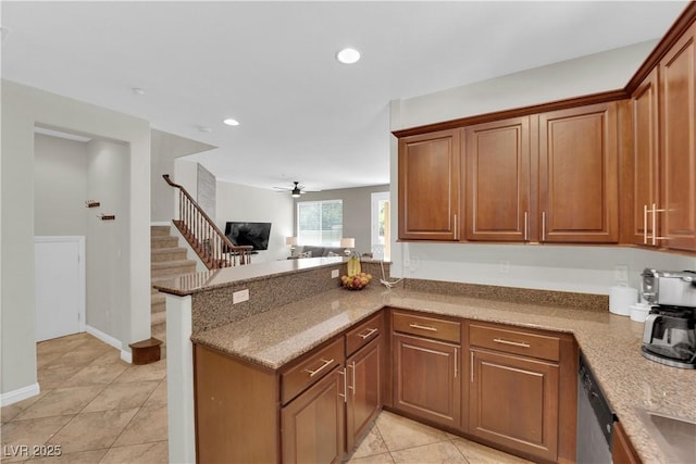 kitchen featuring a peninsula, dishwasher, brown cabinetry, and ceiling fan