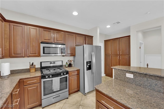 kitchen featuring stainless steel appliances and brown cabinets