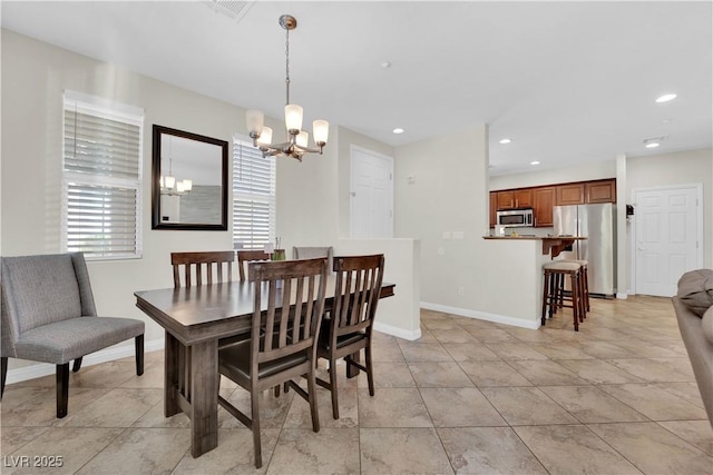 dining room featuring baseboards, visible vents, a chandelier, and recessed lighting