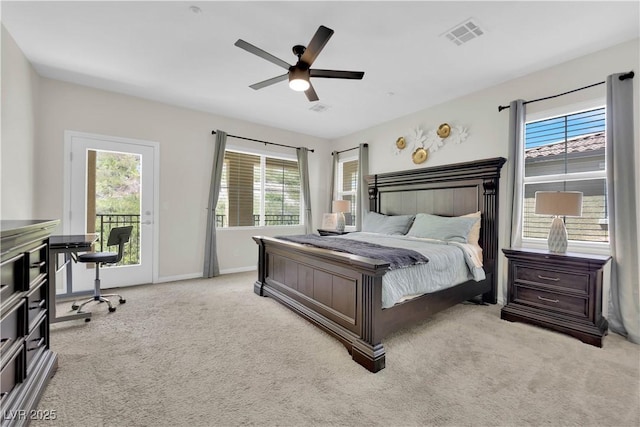 carpeted bedroom featuring multiple windows, visible vents, and access to exterior