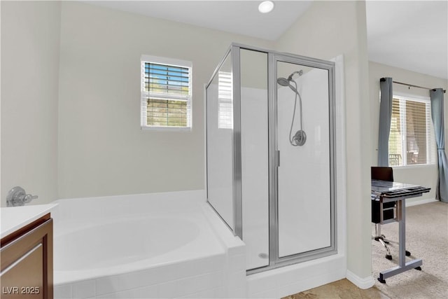 full bath with a garden tub, vanity, and a shower stall
