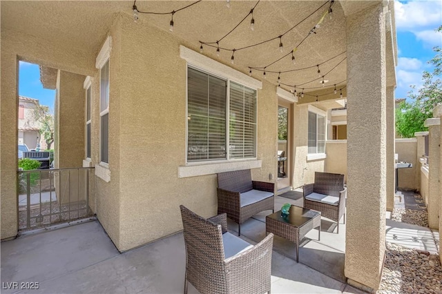 view of patio / terrace featuring an outdoor hangout area and fence