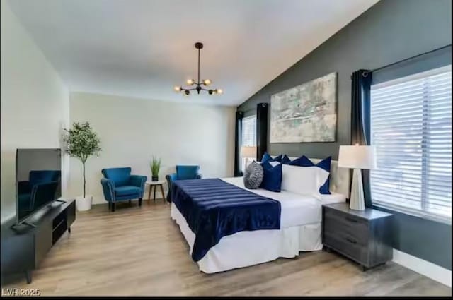 6736 Quinella Dr, Las Vegas, NV 89103 - bedroom featuring vaulted ceiling, a notable chandelier, baseboards, and light wood-style floors