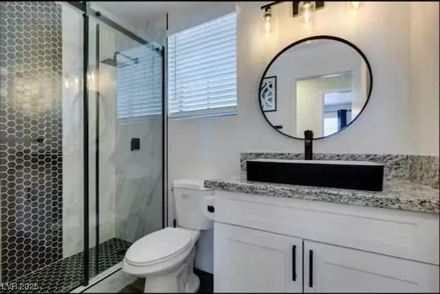 6736 Quinella Dr, Las Vegas, NV 89103 - bathroom featuring a stall shower, vanity, and toilet